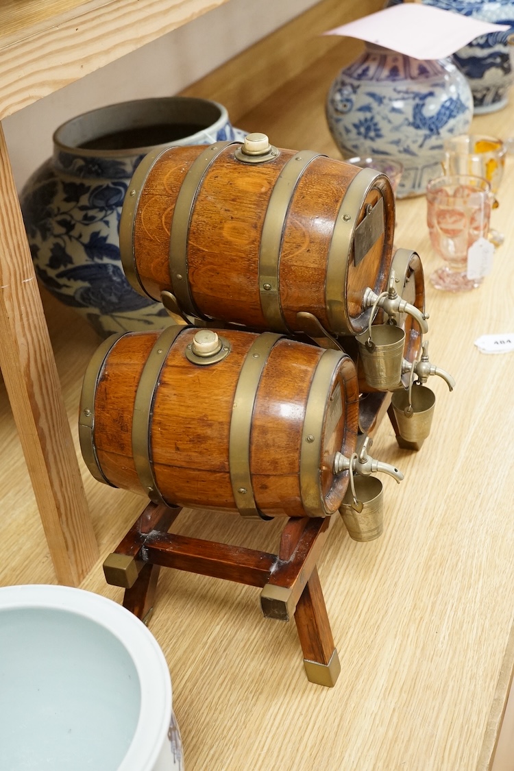 A set of three coopered oak and brass bound spirit barrels and stand, ivory mounted, early 20th century, 39cm wide. CITES Submission reference L87V7979